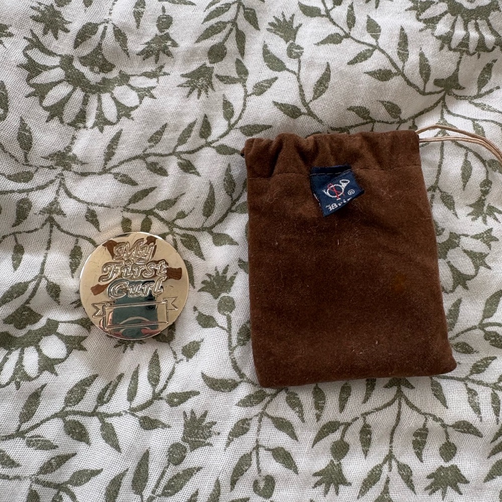 silver case “my first curl” with brown velvet dust bag